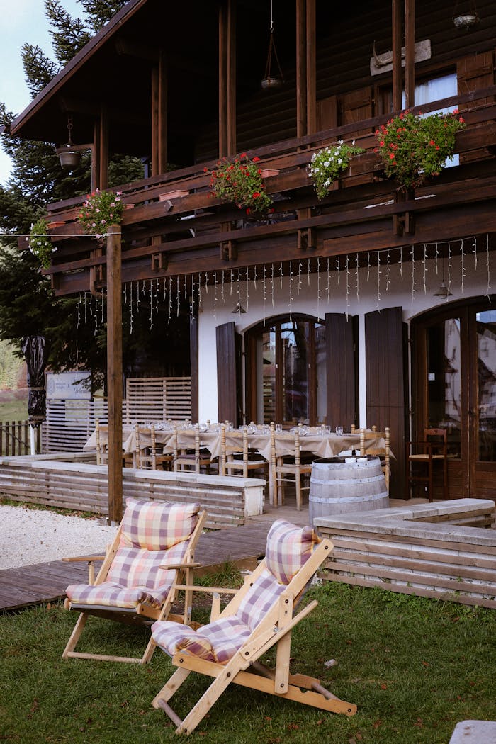 about-us Cozy chalet with rustic decor, outdoor seating, and vibrant flowers.